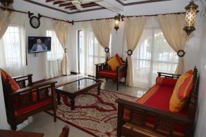 a living room with a couch and a table at Beytul Habaib in Lamu