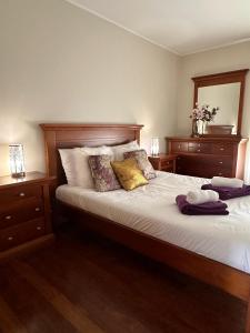 a bedroom with a large bed with white sheets and pillows at Azor International Apartment II in Ponta Delgada