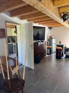 a room with a room with a kitchen and a table at Gîte chez Marco in Peyrieu