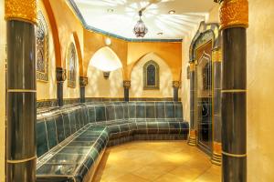 a room with a bench in a building with columns at Landgasthof Karner in Frasdorf +92 photos