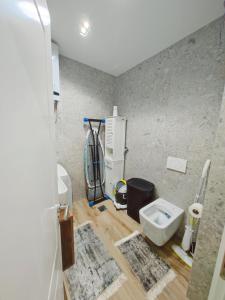 a bathroom with a sink and a toilet at The Loft Luxury Apartment in Shkodër +8 photos