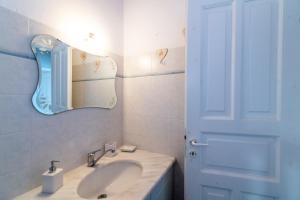 a white bathroom with a sink and a mirror at Porto Blue Horizon in Agios Ioannis +36 photos