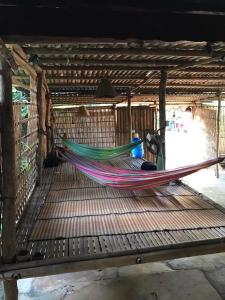 a hammock on a table in a building at Happy Homestay Banlung & Trekking in Banlung