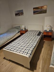 a bedroom with two beds and two night stands at Modernes Work and Stay Apartment Nähe Attendorn und Plettenberg für 5 Personen in Plettenberg +4 photos