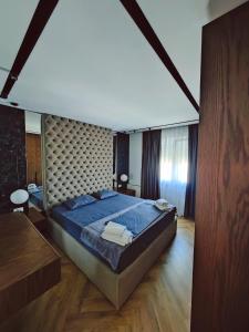 a large bedroom with a large bed in a room at The Loft Luxury Apartment in Shkodër