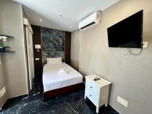 a hotel room with a bed and a flat screen tv at Costa Marbella Star Light in Marbella