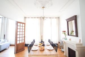 a dining room with a long table with chairs at -BOSCO- Elegant T3 avec balcon et vue sur le port in Concarneau