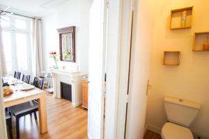 a room with a table and a sink and a toilet at -BOSCO- Elegant T3 avec balcon et vue sur le port in Concarneau +21 photos