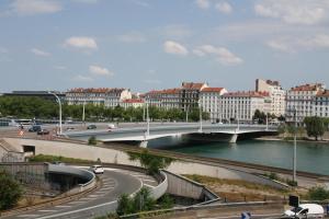 a bridge over a river in a city with buildings at Chez Mo in Lyon