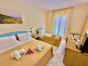 Postel nebo postele na pokoji v ubytování Hotel Alizé