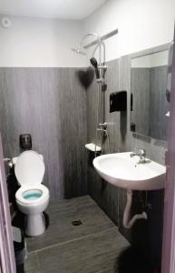 a bathroom with a toilet and a sink at Hippie City Hostel in Chania Town