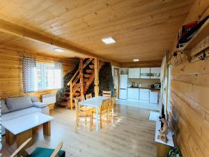a living room with a couch and a table at Domek na Berechu Domek w Górach-Pieniny in Szlachtowa