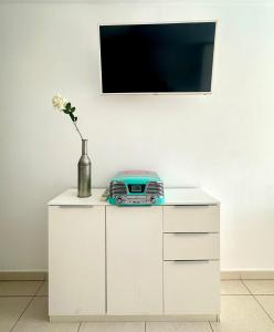 a white cabinet with a television and a radio on it at Amazing Complex Costa Adeje Pool view & Relax in Adeje