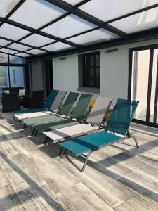 a row of chairs sitting on top of a building at MAISON FAMILLE in Saint-Gervais