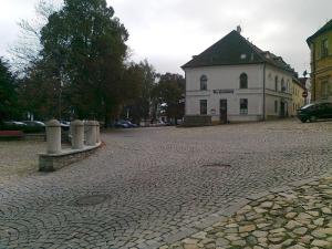 a cobblestone street in front of a white building at Pension Na Hradbach in Tábor