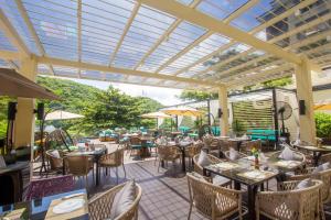 an outdoor restaurant with tables and chairs and awning at Fairways and Bluewater Boracay in Boracay