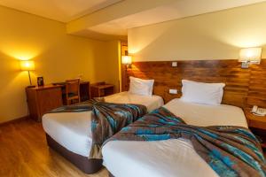 Postel nebo postele na pokoji v ubytování Hotel Caravelas