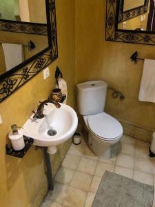 a bathroom with a white toilet and a sink at Dar Fezna - top location, stunning 360 views in Chefchaouen +28 photos