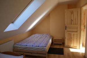 a bedroom with a bed and a skylight at Domek Jantar in Jantar