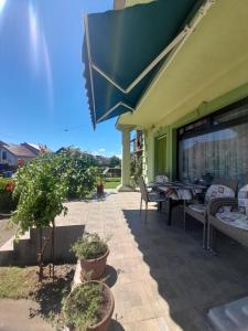 a patio of a restaurant with chairs and tables at Apartment Kolonija in Slavonski Brod