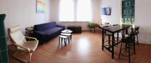 a living room with a blue couch and a table at Serenity Ferienwohnungen in Gotha in Gotha