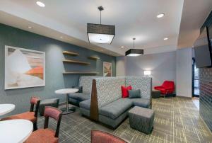 a living room with a couch and tables and chairs at Hampton Inn & Suites Burlington in Burlington