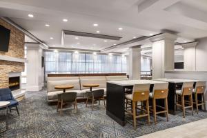 a lobby with tables and chairs and a fireplace at Homewood Suites by Hilton Washington, D.C. Downtown in Washington