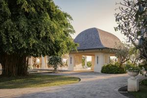 a house with a gambrel roof and a driveway at Jumeirah Bali in Uluwatu
