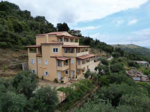an image of a house on a hill at Nefeli's Apartment in Himare