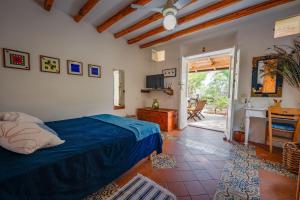 a bedroom with a bed and a door to a patio at Casa Scirocco Lipari in Lipari