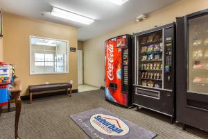 a room with a cocacola soda machine next to at Suburban Studios near University of North Carolina-Charlotte in Charlotte
