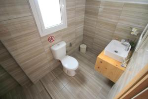 a small bathroom with a toilet and a sink at Nefeli's Apartment in Himare