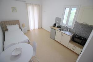 a small room with a bed and a sink in it at Nefeli's Apartment in Himare +44 photos
