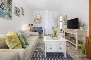 Una sala de estar con un sofá y un televisor. en Apartment By The Sea, en San Andrés