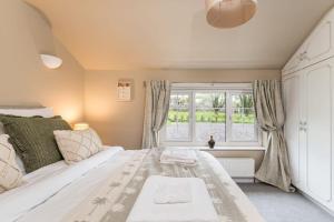 - une chambre avec un grand lit blanc et une fenêtre dans l'établissement Malham Wellbeing 1-bed Retreat With Hot Tub, à Malham