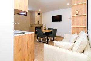 a kitchen and living room with a couch and a table at Villa Maria Caetana in Frazão