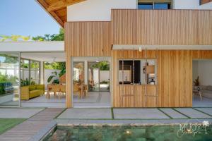 a house with a pool in front of it at Villa Mango Beach, face au lagon de l'Ermitage in La Saline les Bains
