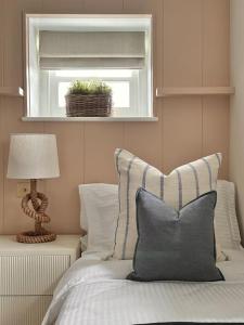 a bedroom with a bed with a window and a pillow at Tobias Apartment, 2 Bedroom, Aberaeron in Aberaeron +2 photos