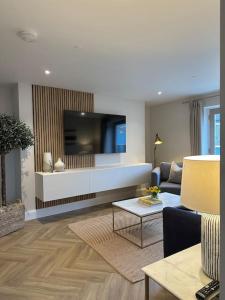 a living room with a couch and a tv at Tobias Apartment, 2 Bedroom, Aberaeron in Aberaeron