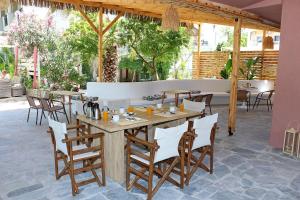 a restaurant with a wooden table and chairs at Kristal Hotel in Prinos