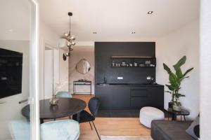 a living room with a table and chairs at LUXE VISTA City Apartments Algund in Lagundo