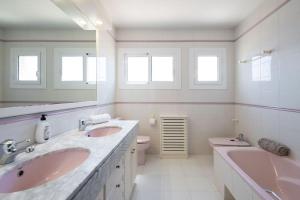 a white bathroom with two sinks and a toilet at Casa Nina junto Barcelona Centro y playa in Teià +38 photos