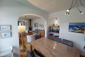 a dining room and living room with a table and chairs at Beautiful family house in Meucon in Meucon