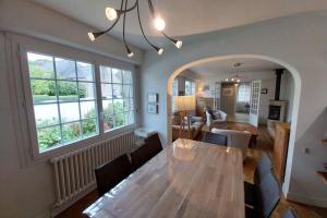 a dining room with a table and a living room at Beautiful family house in Meucon in Meucon