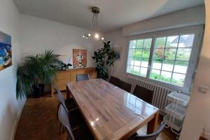 a dining room with a wooden table and chairs at Beautiful family house in Meucon in Meucon +25 photos