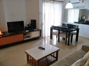 a living room with a table and a dining room at Bayan Baru in Bayan Lepas