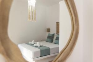 a bedroom with a bed and a mirror at Summer Residence in Provatas
