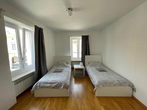 a bedroom with two beds and a window at Apartment Tartini in Piran