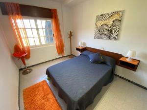 a bedroom with a blue bed and a window at Apartamentos Blanco Y Negro in A Guarda +237 photos