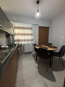 a kitchen with a table and chairs in a room at Iancu in Brăila +9 photos